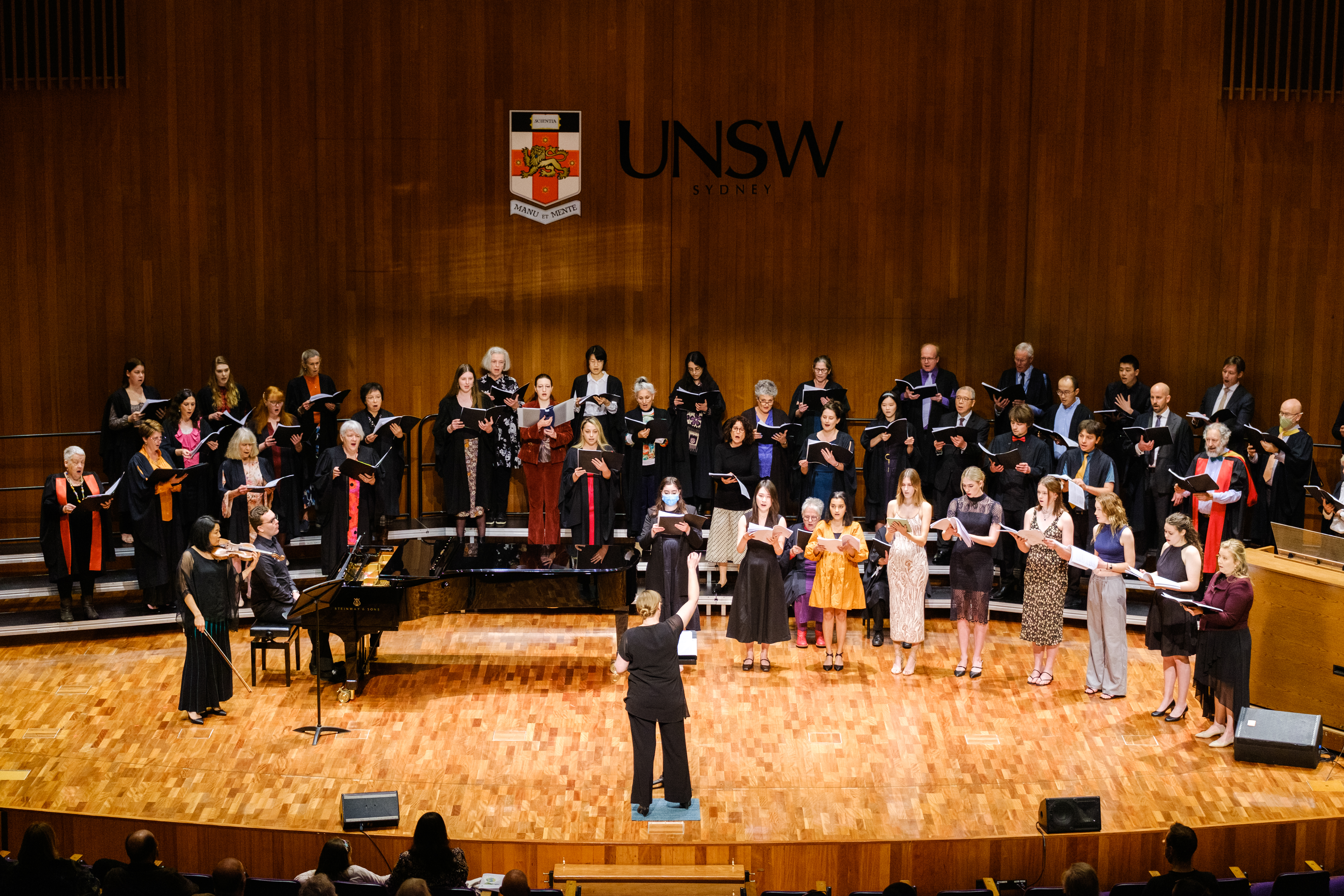 Large choir on stage with conductor